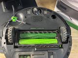 someone is cleaning the floor with a vacuum cleaner and a green brush
