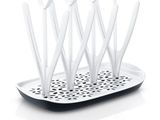 several toothbrushes are in a holder on a white tray