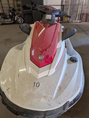 a red and white jet ski parked in a garage