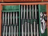 a wooden box filled with silverware and utensils