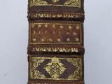three old books stacked on top of each other on a table