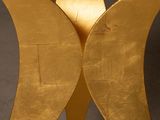 a gold sculpture of a butterfly that is on display
