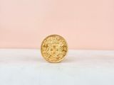 a gold coin sitting on top of a white counter