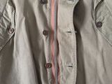 a close up of a jacket on a hanger on a wall
