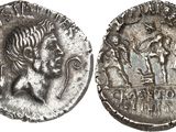 a silver coin with an image of a man and a woman on it