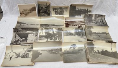 several old black and white photos of people and buildings on a bed