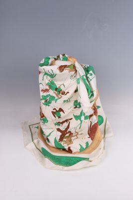 a white hat with a green and brown design on it