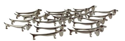 a lot of silver dog shaped dishes on a white table
