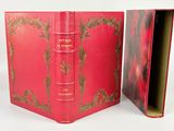 a red book that is open on a white surface