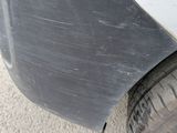 a close up of a car ' s front bumper and tire