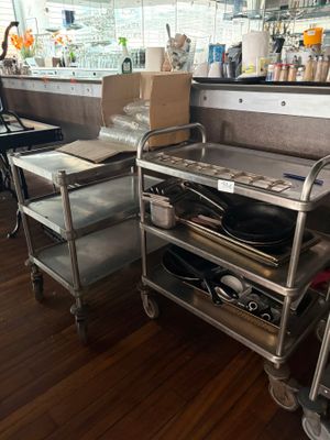 a silver cart with a pan on it in a kitchen