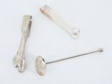 two spoons and a spoon rest next to each other