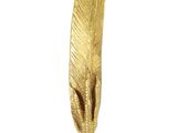 a gold feather shaped object on a white surface