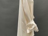 an image of a mannequin wearing a white dress and hat