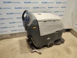 a machine that is sitting on the ground in front of a wall