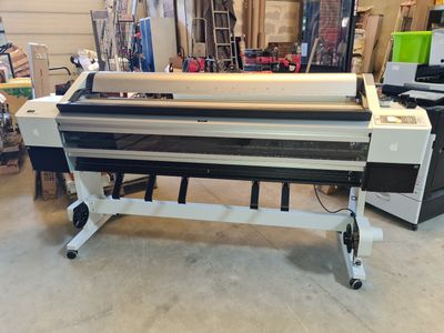 an image of a large ploter machine in a warehouse