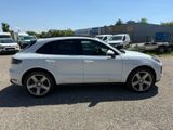 the white porsche cayen is parked in the parking lot