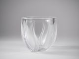 a clear glass cup with a curved design on it