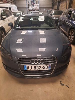 a car that is parked in a garage with other cars in the background