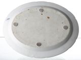 a white plate with holes on it sitting on a table