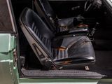 a green car with black leather seats in the back of it