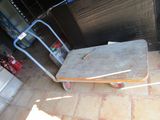 a cart with a wooden board on it in a garage