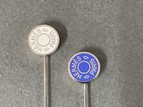 two pins that have been placed next to each other