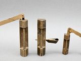 four pieces of wood that have been carved into the shape of a crane