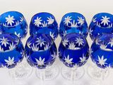 six blue glass wine glasses with white flowers on them