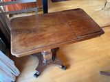 a wooden table with two chairs on it in a living room