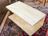 a coffee table that is sitting on a rug in a living room
