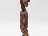 a wooden sculpture of a man with a hat on his head