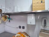 a kitchen with a lot of clutter on the counter