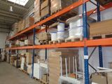 many boxes and containers on the shelves in the warehouse