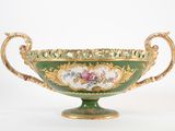 un bol vert et doré orné d'un motif floral