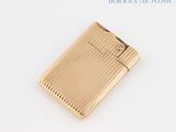 a gold lighter that is sitting on a table