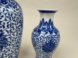 two blue and white vases sitting next to each other