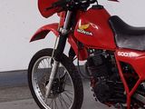 a red motorcycle that is parked in a garage