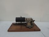 a small model of a steam engine on a wooden stand