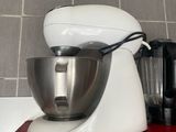 a white mixer and a blender sitting on a red counter