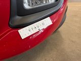 a close up of a red car with a sticker on it