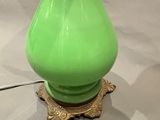 a green vase that is sitting on a table