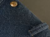 a close up of a denim jacket with a button on it