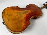 a close up of a violin on a white surface