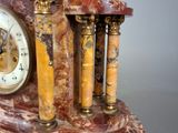 a clock with a statue of a dog on top of it