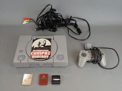 a video game console with a game controller next to it