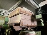 many boxes stacked on top of each other in a room