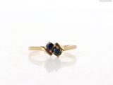 an image of a close up of a gold ring with a sapphire stone
