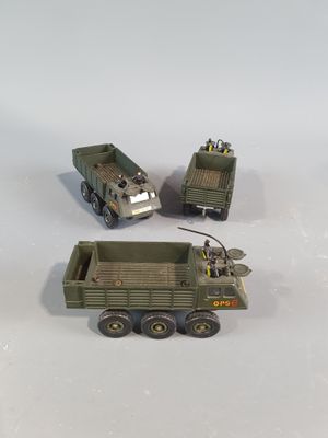 three toy army vehicles that are sitting on a table