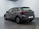 the rear end of a grey volkswagen vw polo parked in a garage